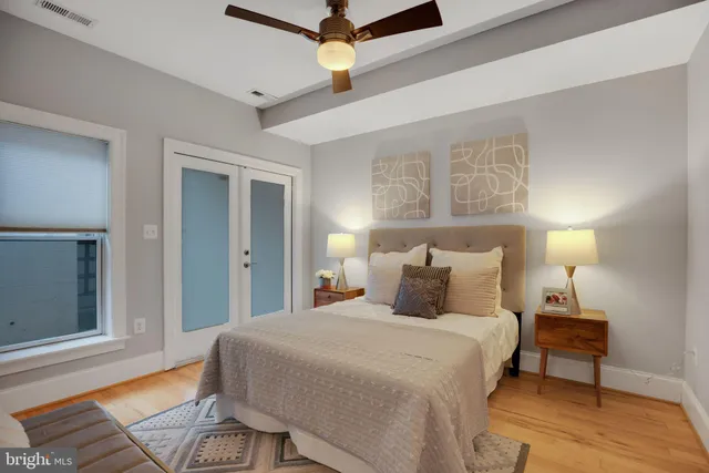 a bedroom with a bed and a chandelier