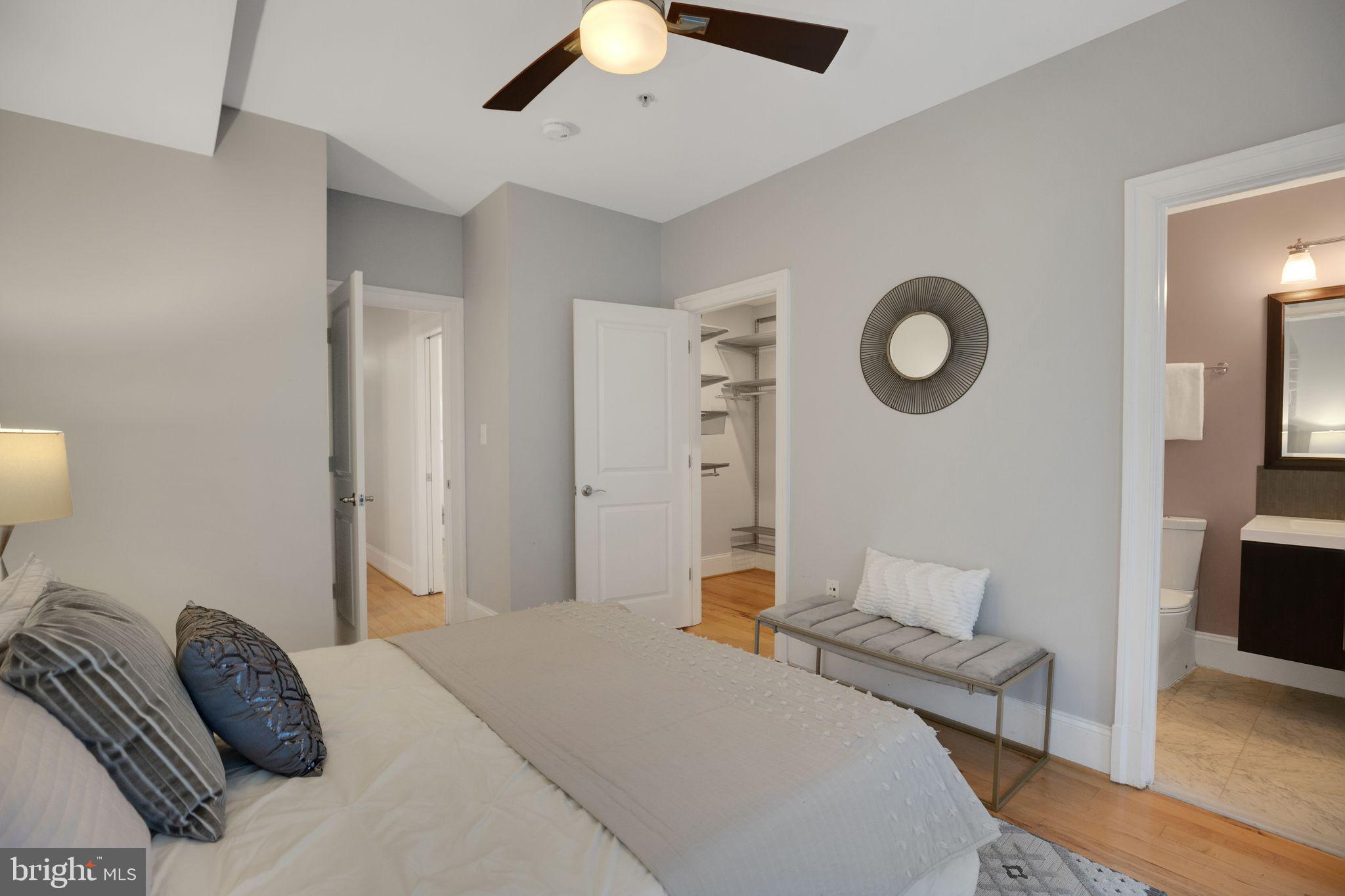 2106 10th Street Northwest, Unit 1 Washington, DC 20001 - Photo 20 of 31 a bedroom with a bed couch and a flat tv screen