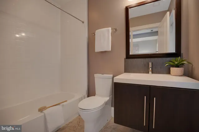 a bathroom with a sink toilet and mirror