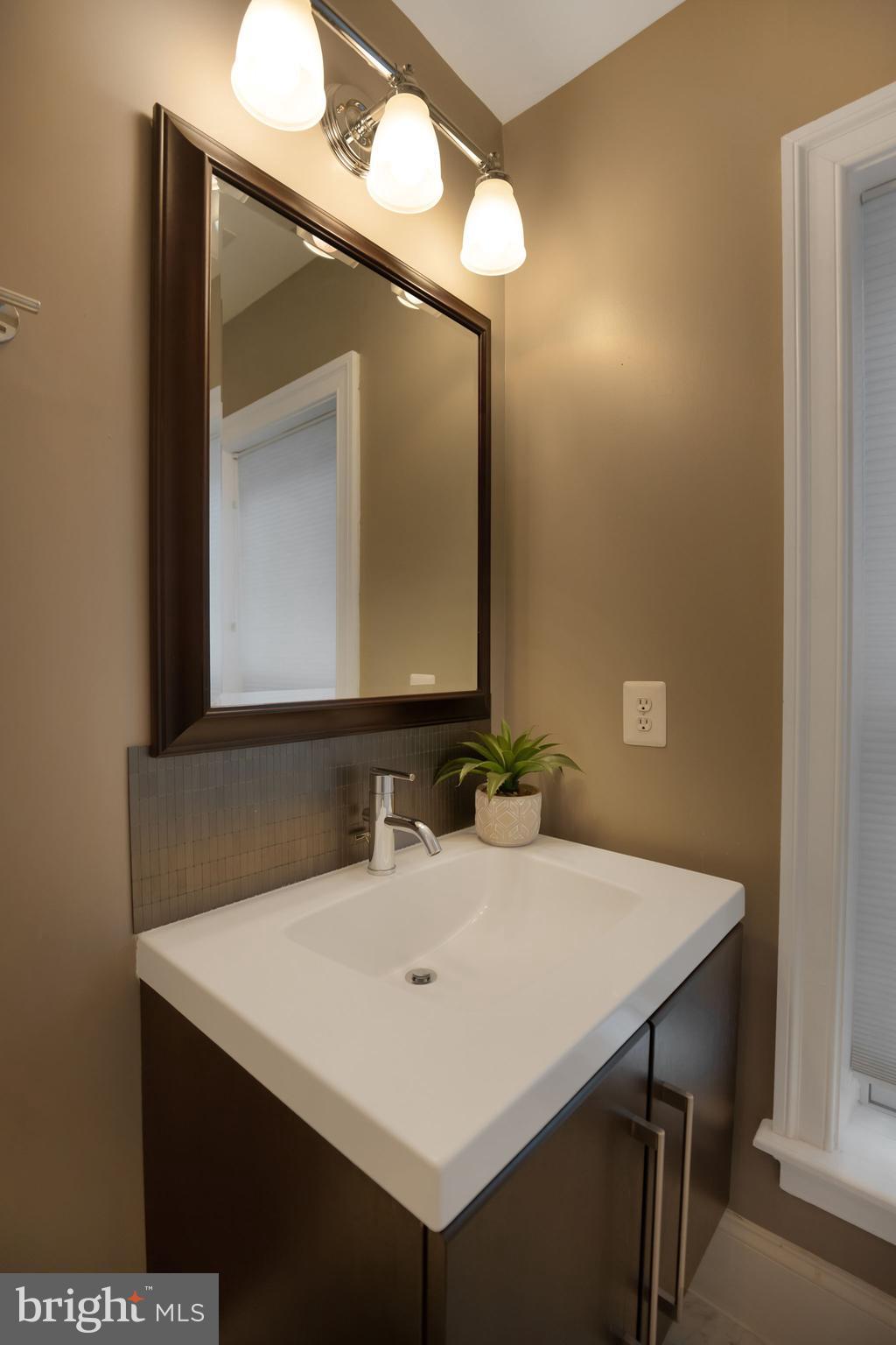 2106 10th Street Northwest, Unit 1 Washington, DC 20001 - Photo 23 of 31 a bathroom with a sink vanity and a mirror