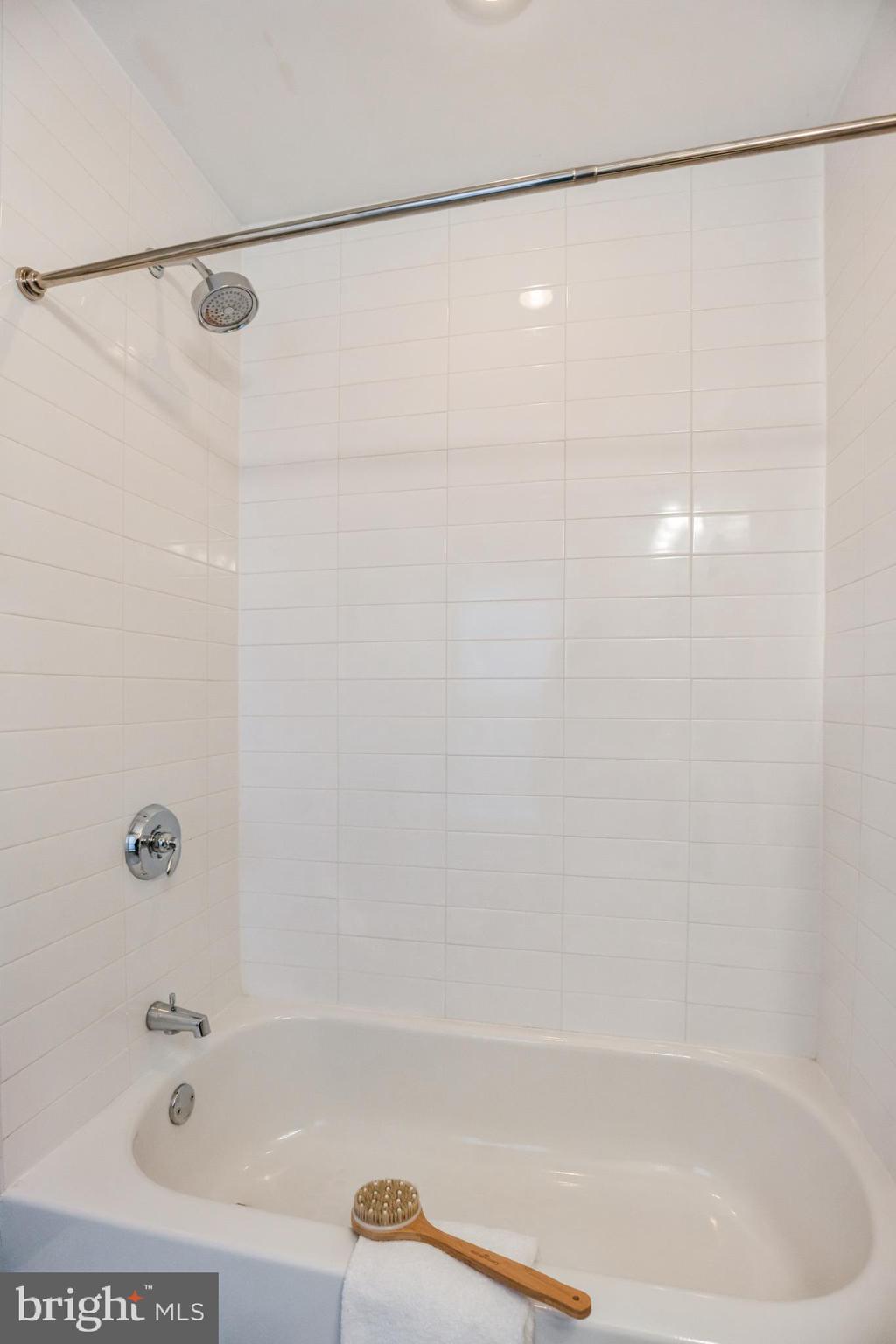 2106 10th Street Northwest, Unit 1 Washington, DC 20001 - Photo 24 of 31 a bathroom with a shower and a bath tub