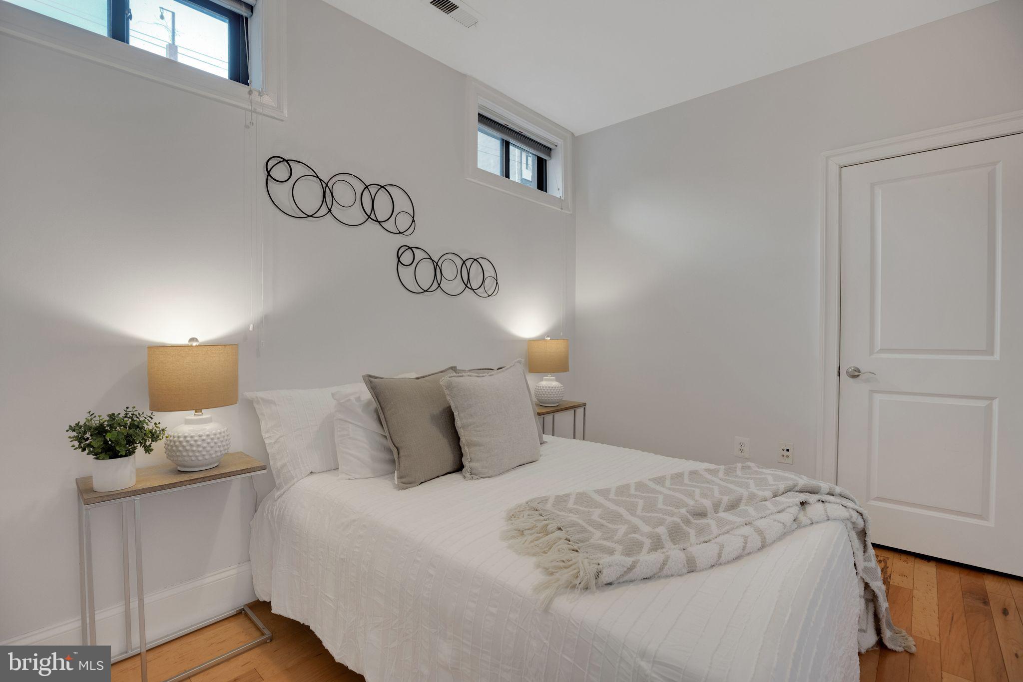 2106 10th Street Northwest, Unit 1 Washington, DC 20001 - Photo 25 of 31 a bedroom with a bed and a night stand