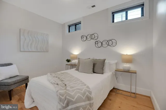 a bedroom with a bed and a lamp