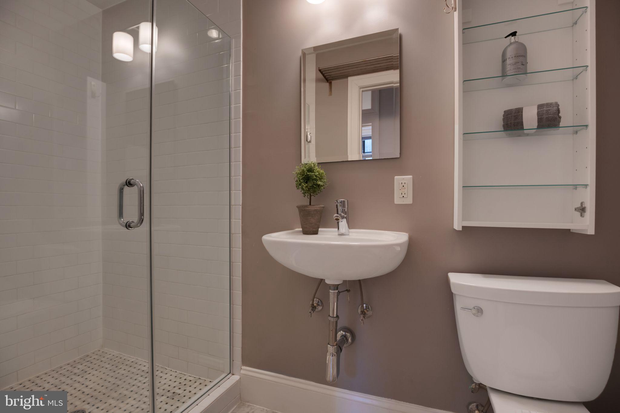 2106 10th Street Northwest, Unit 1 Washington, DC 20001 - Photo 28 of 31 a bathroom with a sink a toilet and shower
