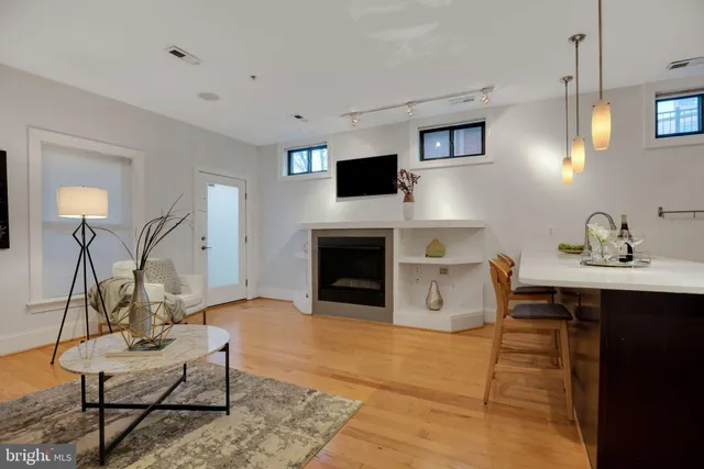a living room with furniture and a fireplace