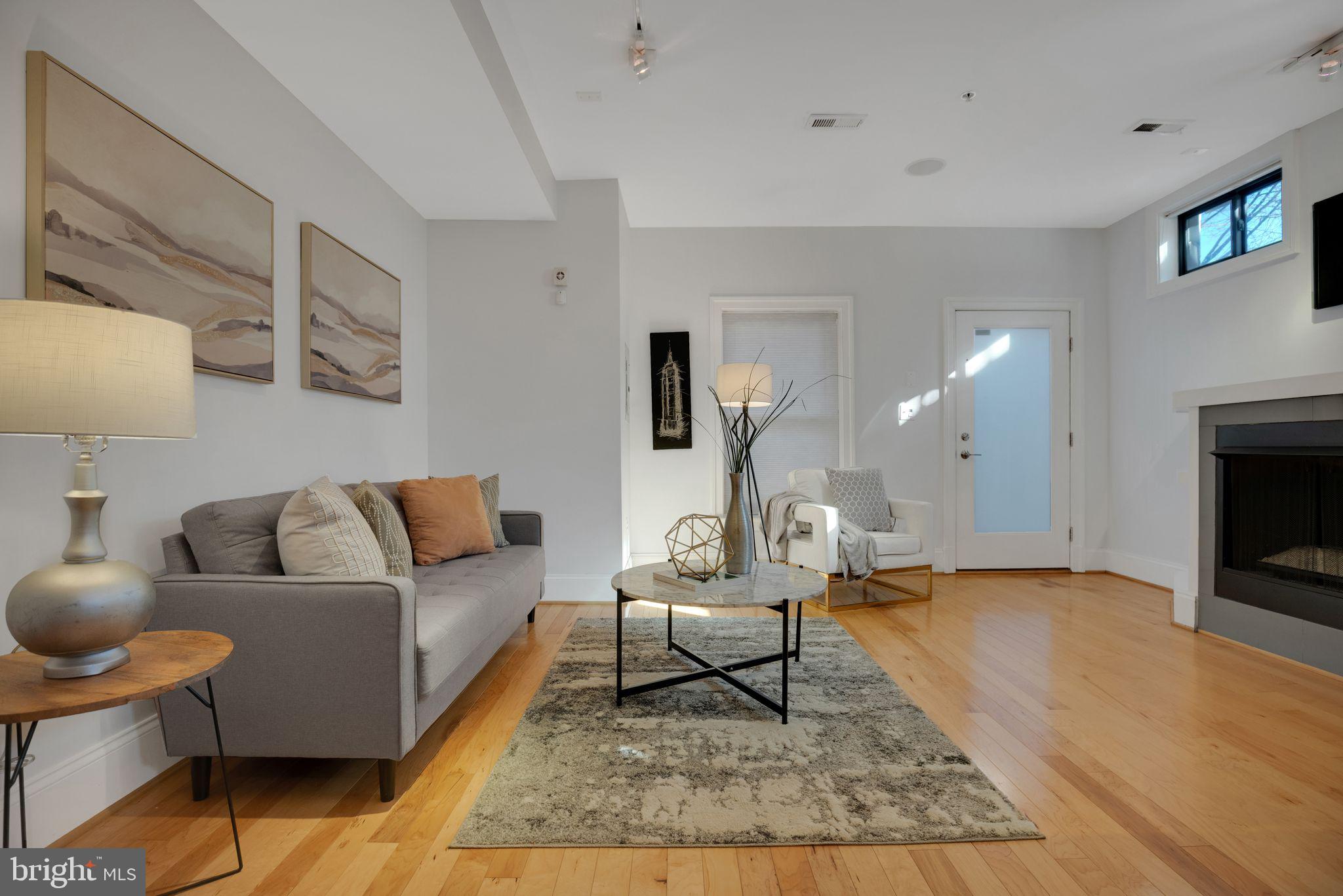 2106 10th Street Northwest, Unit 1 Washington, DC 20001 - Photo 7 of 31 a living room with furniture and a fireplace