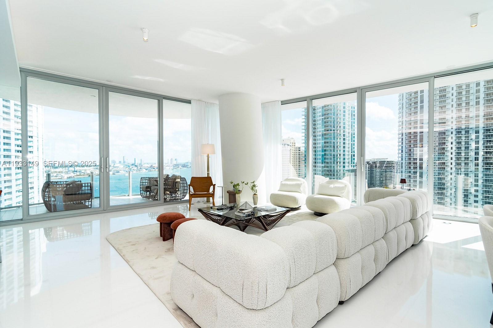 300 Biscayne Blvd Way, Unit 1901 Miami, FL 33131 - Photo 11 of 57 a spacious bedroom with furniture and large windows