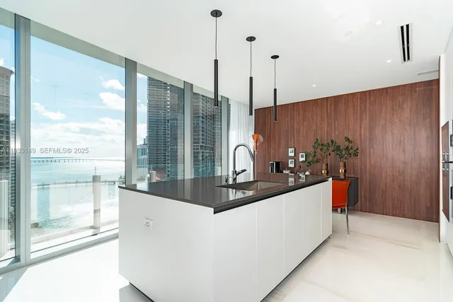 a living room with furniture a flat screen tv and a table