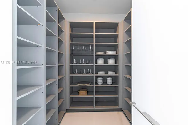a bedroom with a large bed and a flat tv screen on the dresser