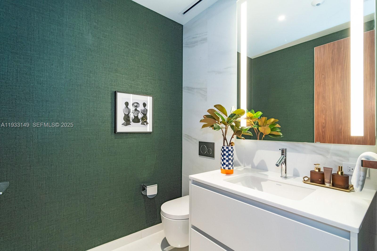 300 Biscayne Blvd Way, Unit 1901 Miami, FL 33131 - Photo 25 of 57 a bathroom with a sink mirror and toilet