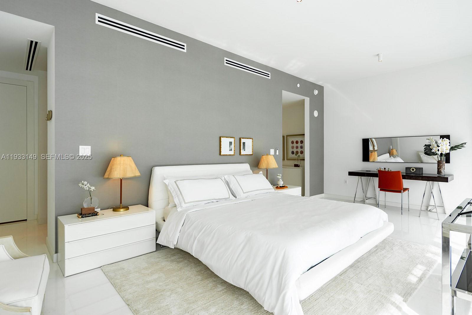 300 Biscayne Blvd Way, Unit 1901 Miami, FL 33131 - Photo 26 of 57 a bedroom with a bed and a lamp