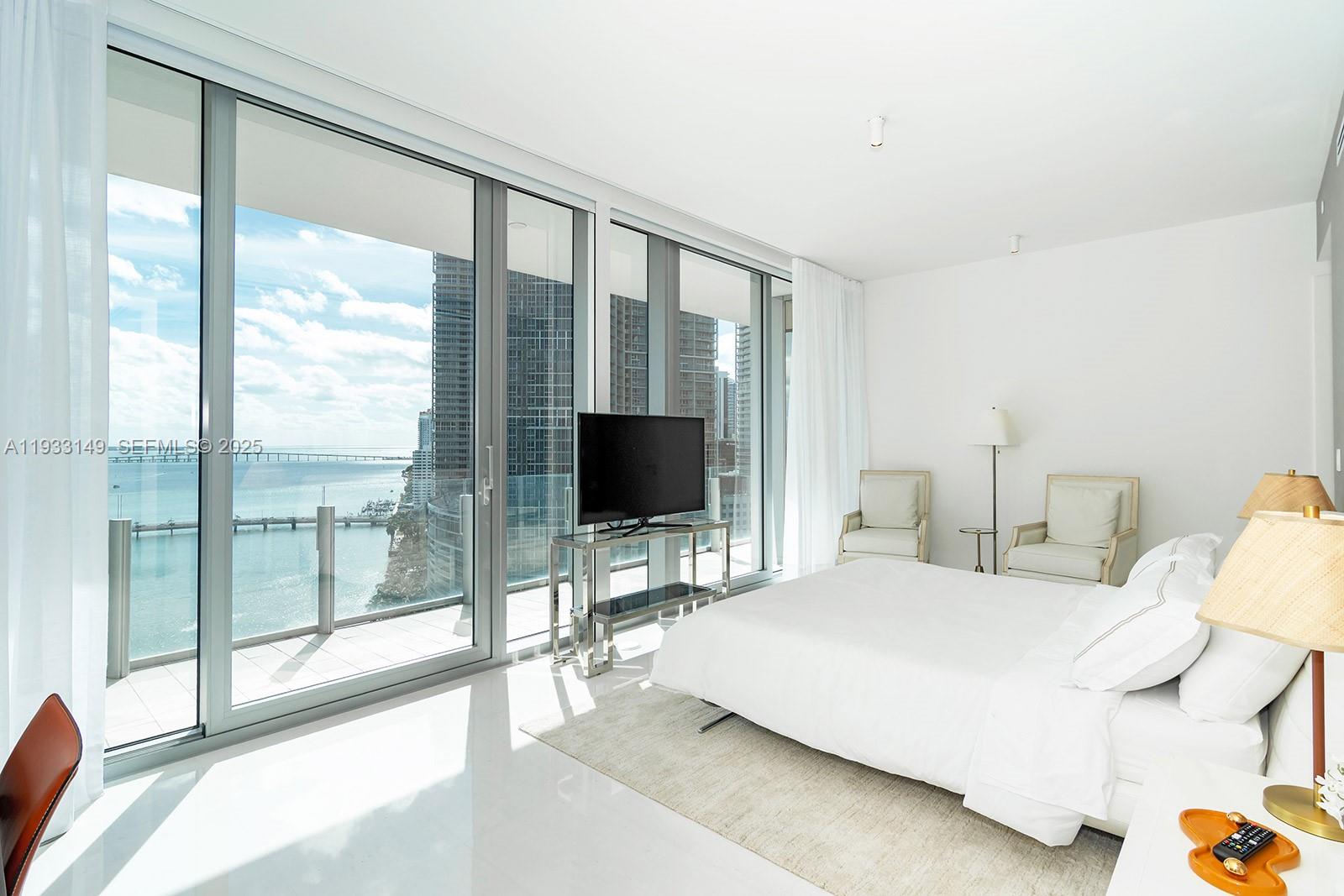 300 Biscayne Blvd Way, Unit 1901 Miami, FL 33131 - Photo 27 of 57 a bedroom with a bed and large window