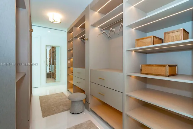 a bathroom with a sink a toilet and a large mirror next to a window