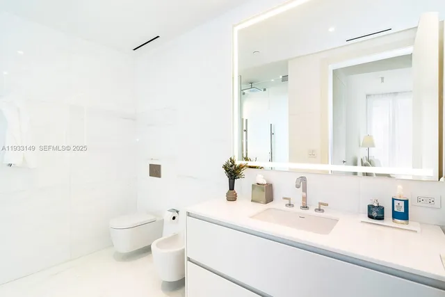 a bedroom with a large bed and a large window