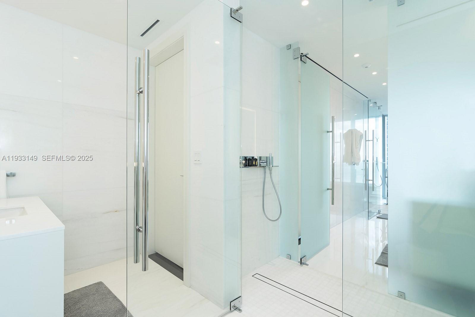 300 Biscayne Blvd Way, Unit 1901 Miami, FL 33131 - Photo 34 of 57 a bathroom with a shower and a glass door