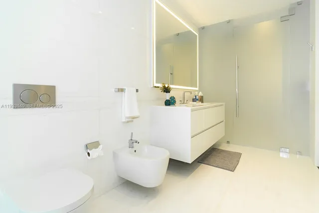 a bathroom with a shower a sink a toilet and a mirror