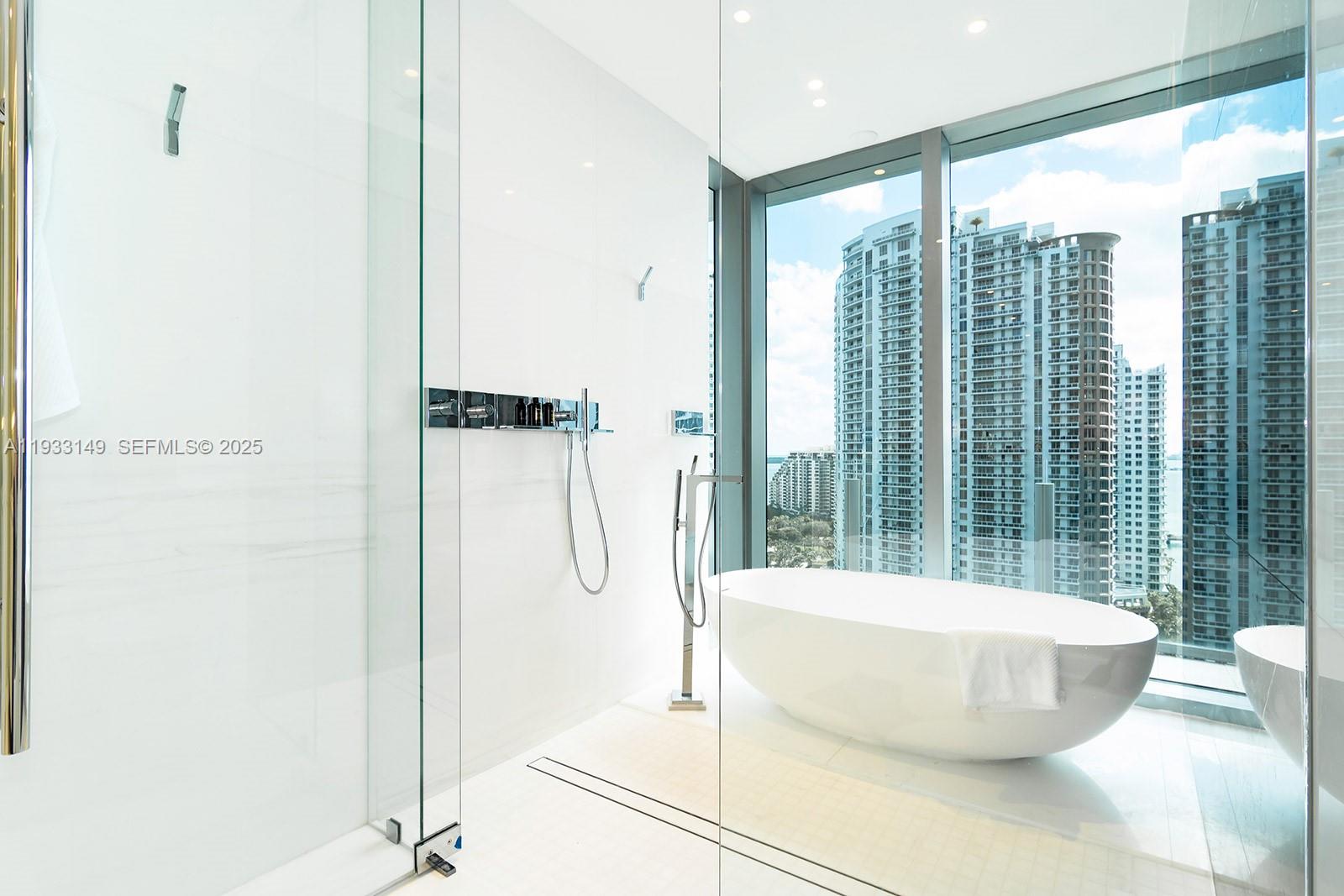 300 Biscayne Blvd Way, Unit 1901 Miami, FL 33131 - Photo 37 of 57 a living room with a large window and a glass door