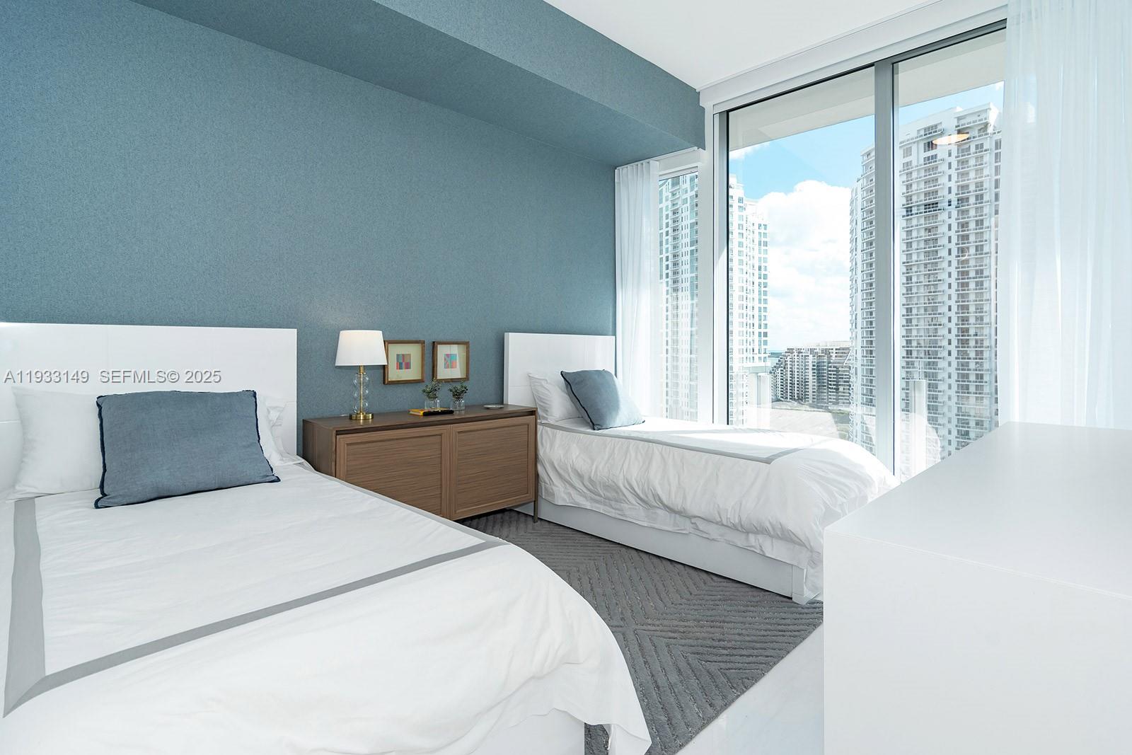 300 Biscayne Blvd Way, Unit 1901 Miami, FL 33131 - Photo 38 of 57 a bedroom with a large bed and a large window