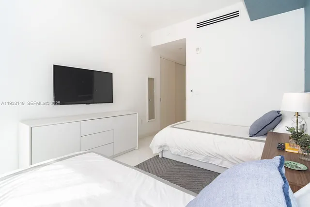 a room with table chairs and painting on the wall