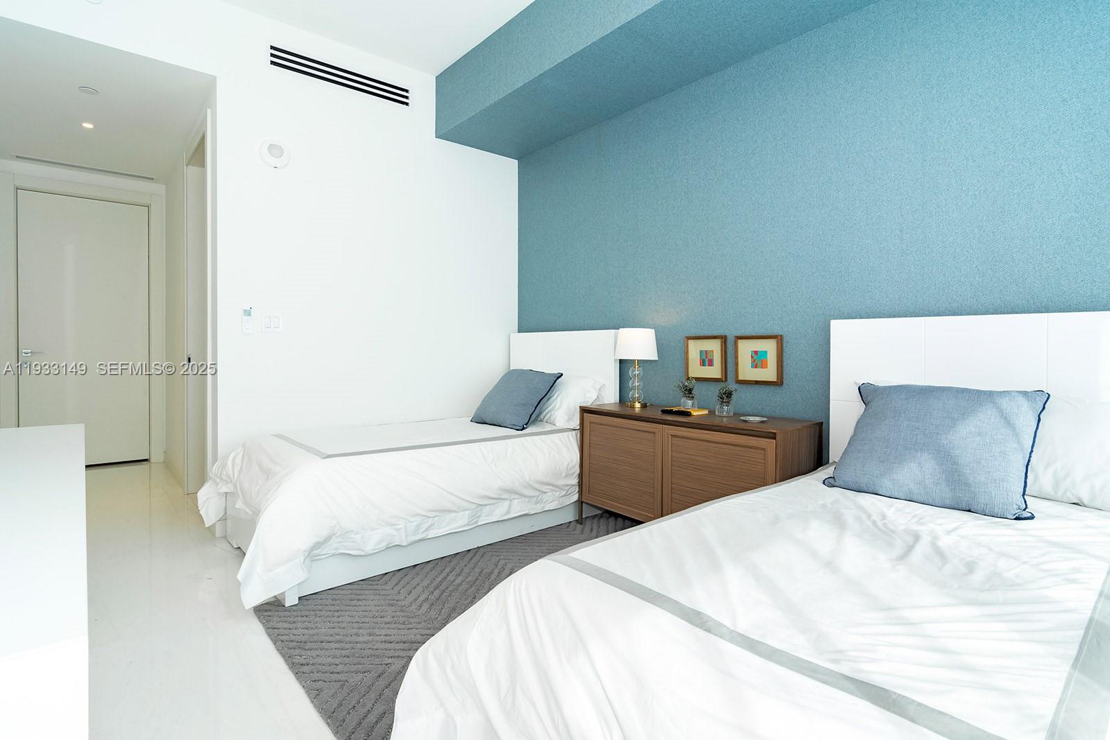 300 Biscayne Blvd Way, Unit 1901 Miami, FL 33131 - Photo 40 of 57 a bedroom with a bed and a night stand