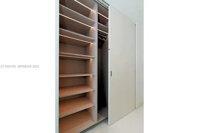 a bedroom with two bed and a window