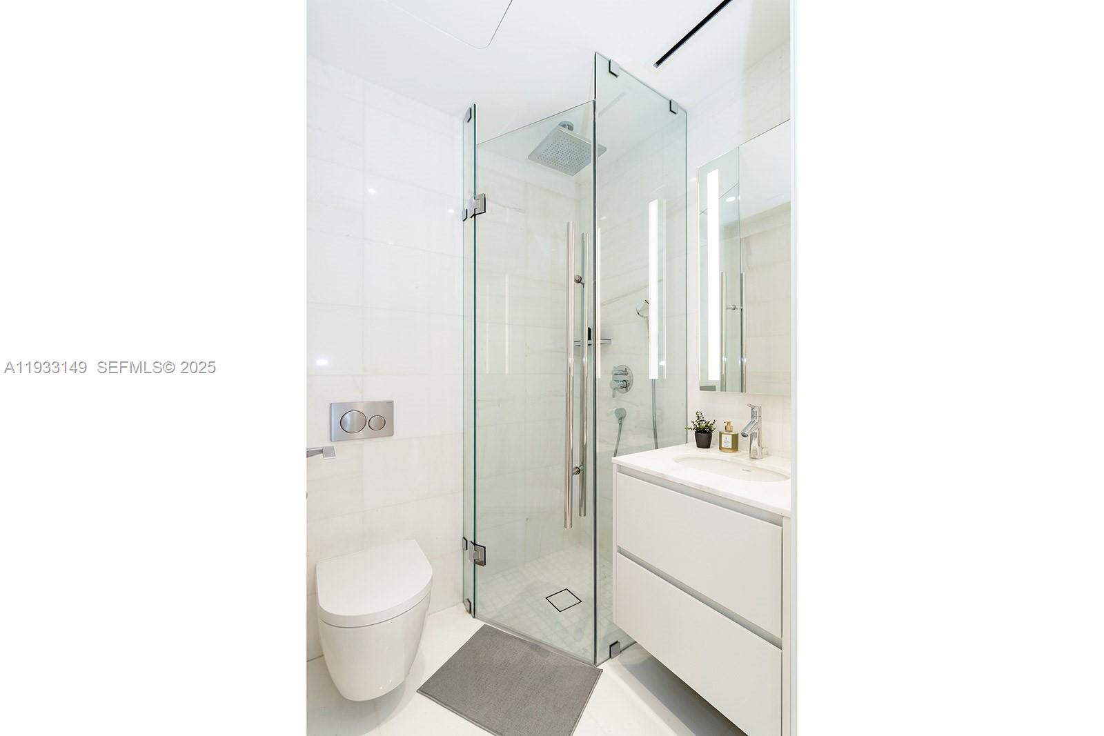 300 Biscayne Blvd Way, Unit 1901 Miami, FL 33131 - Photo 46 of 57 a bathroom with a sink a toilet and shower