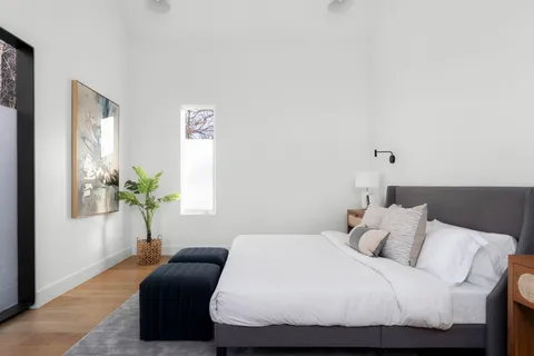 a bedroom with a bed and a window