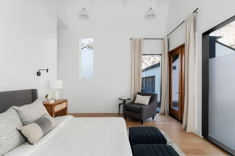 a bedroom with furniture and wooden floor