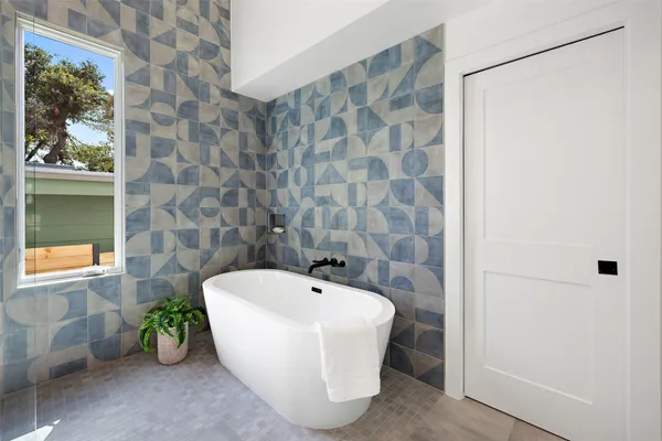 a white bath tub with a window