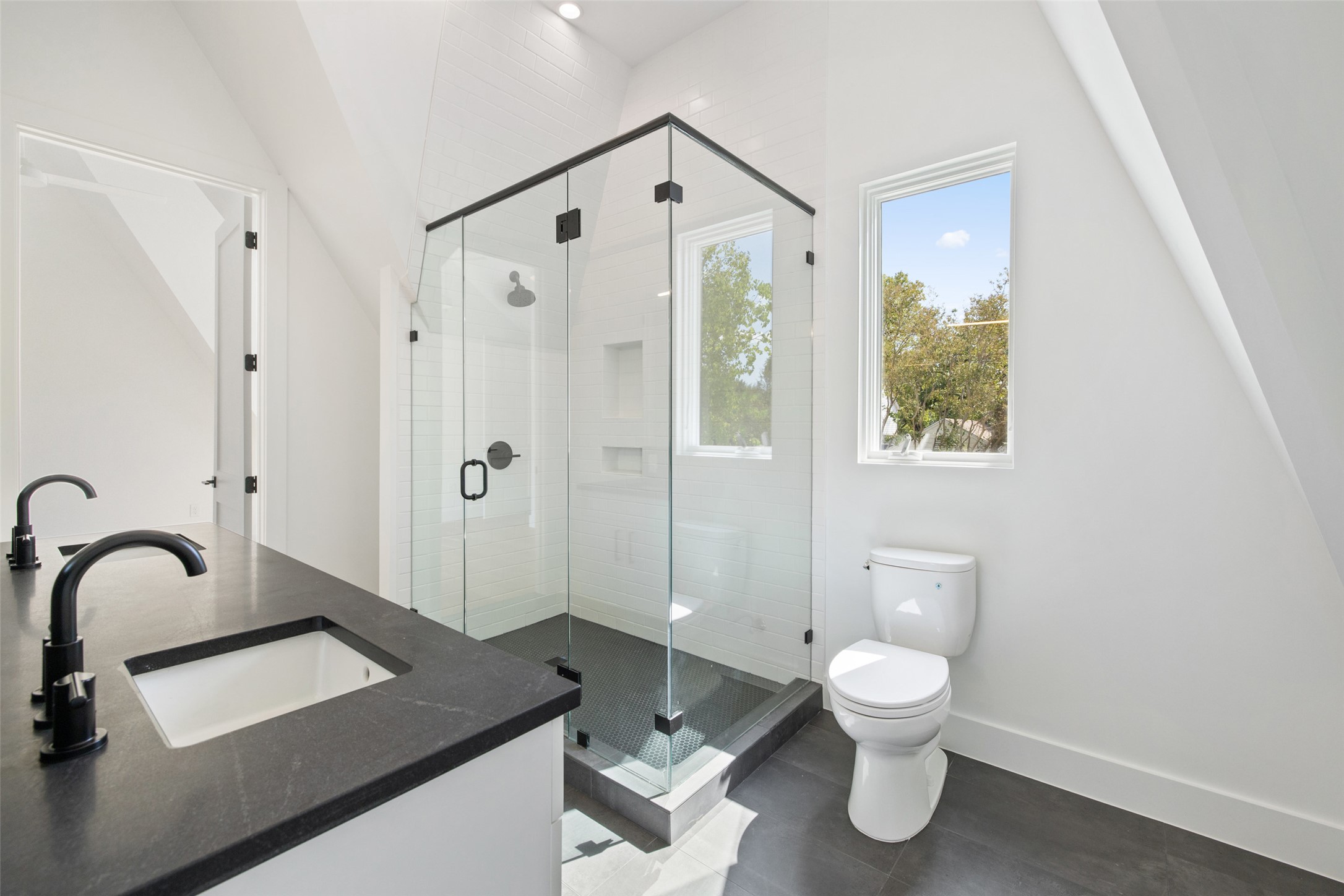 2001 Forest Trail Austin, TX 78703 - Photo 28 of 40 Full bath with double vanity, a shower stall, and recessed lighting