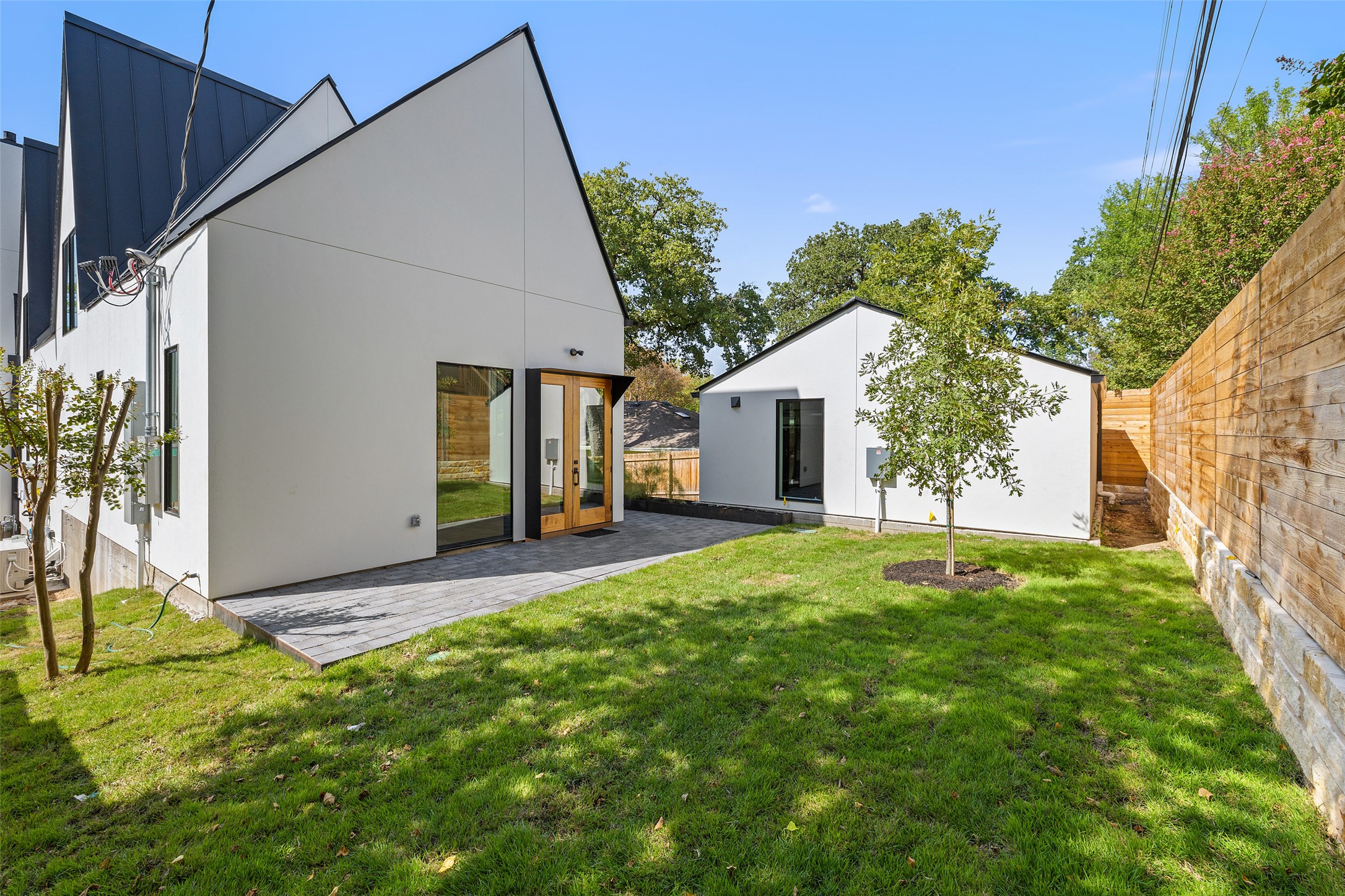 2001 Forest Trail Austin, TX 78703 - Photo 33 of 40 Rear view of property with french doors, stucco siding, a patio, and an outbuilding