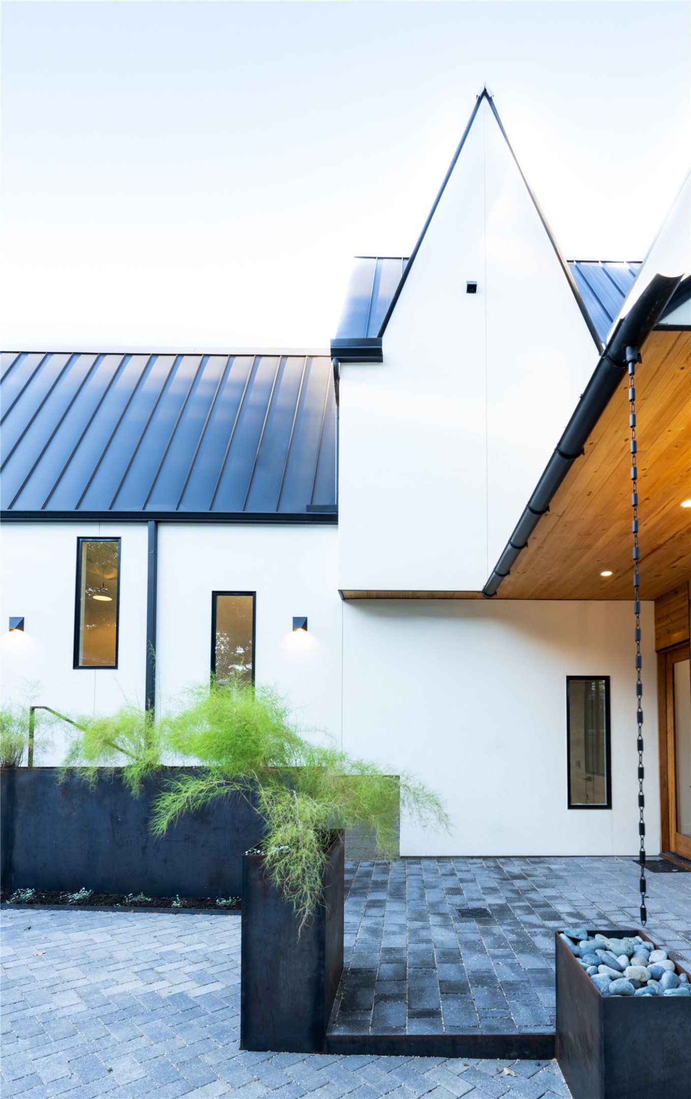 2001 Forest Trail Austin, TX 78703 - Photo 35 of 40 View of side of property featuring a standing seam roof, stucco siding, and a patio area