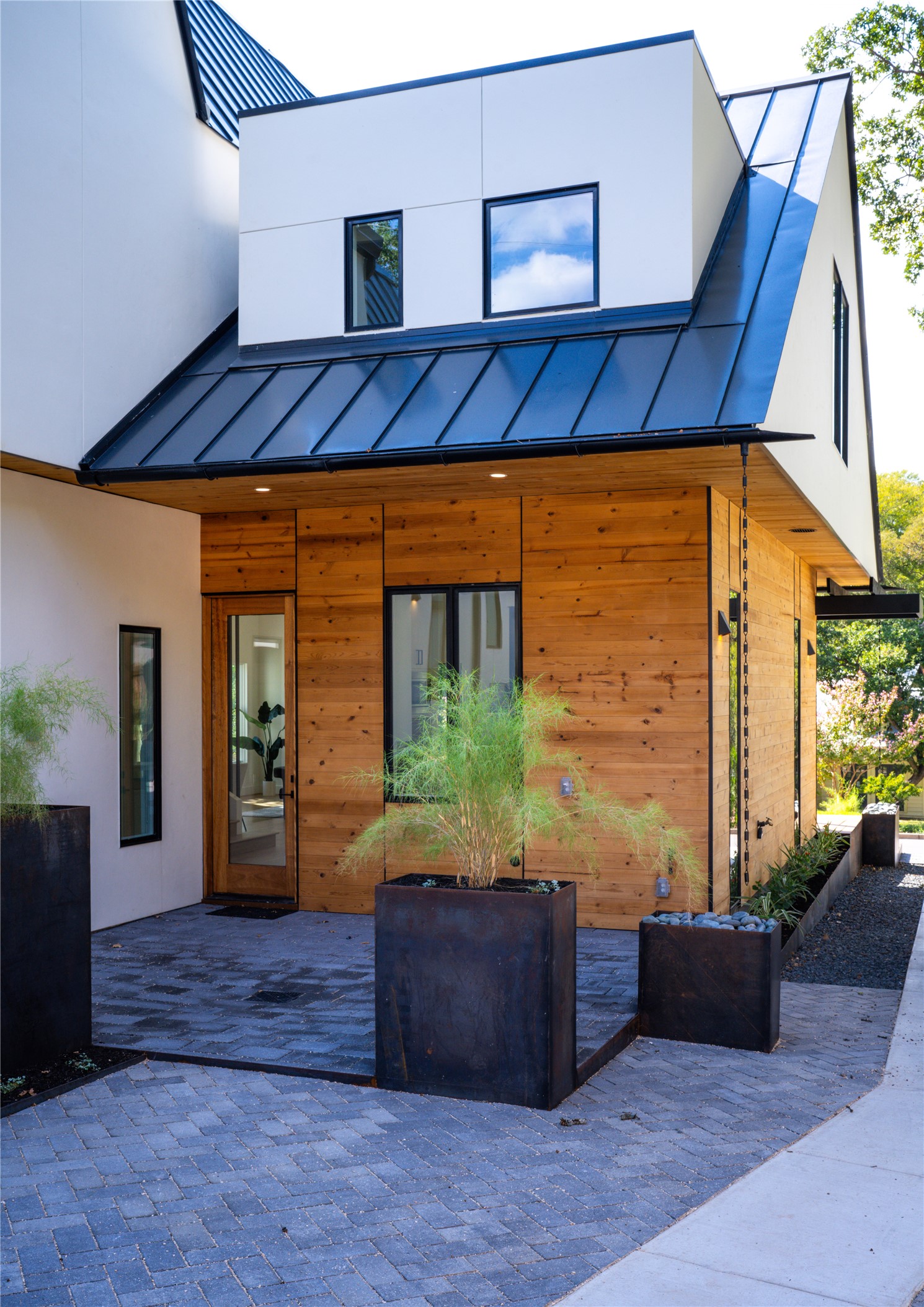 2001 Forest Trail Austin, TX 78703 - Photo 40 of 40 Rear view of property with a standing seam roof, stucco siding, and a patio
