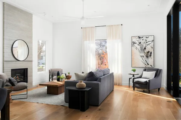 a living room with furniture fireplace and a table