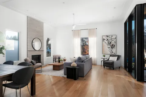 a living room with furniture couches and a mirror