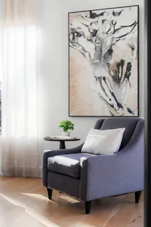 a bedroom with a bed and a wall painting