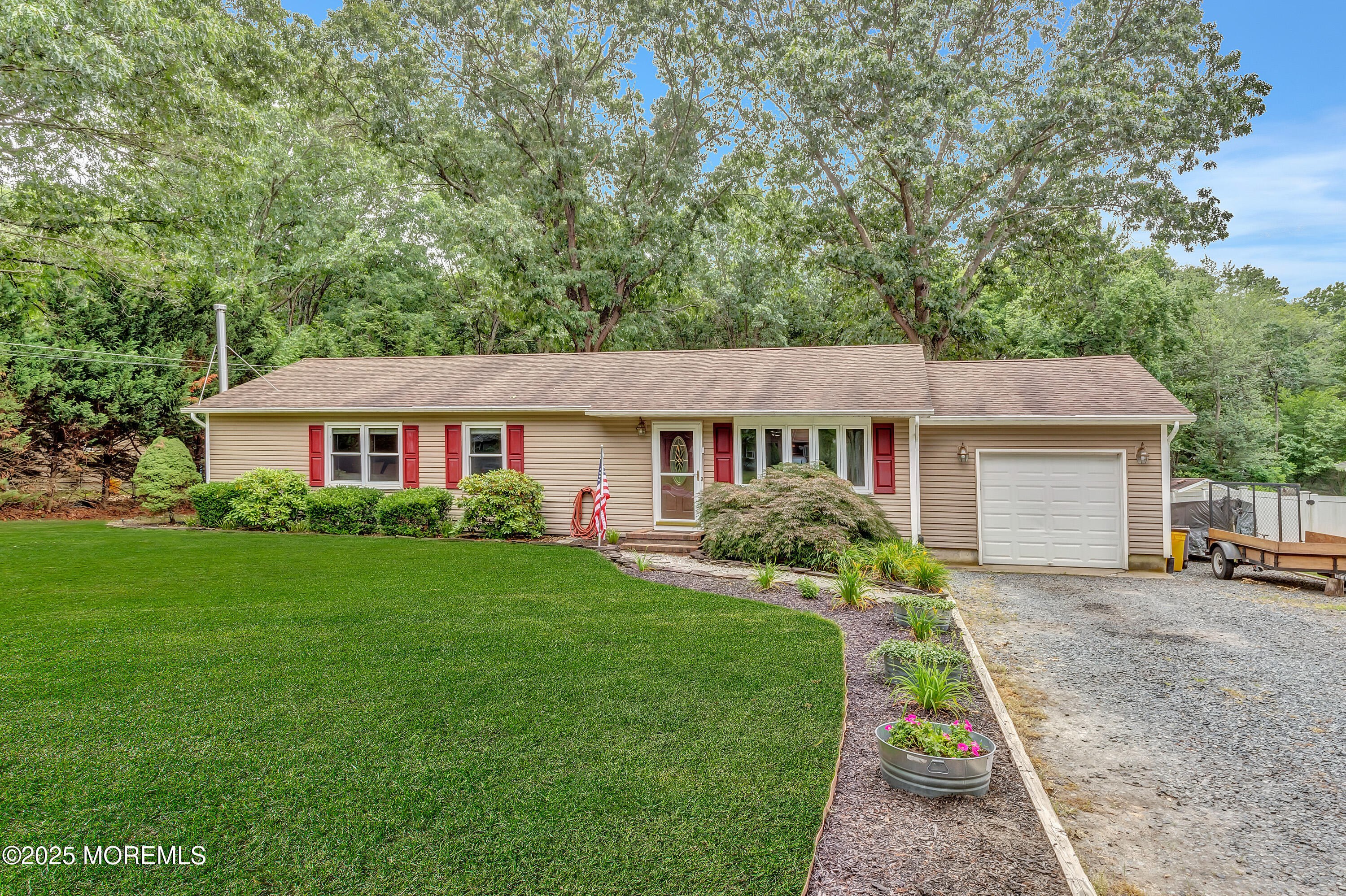 869 Wright Debow Road Jackson, NJ 08527 - Photo 3 of 34 a front view of a house with a garden