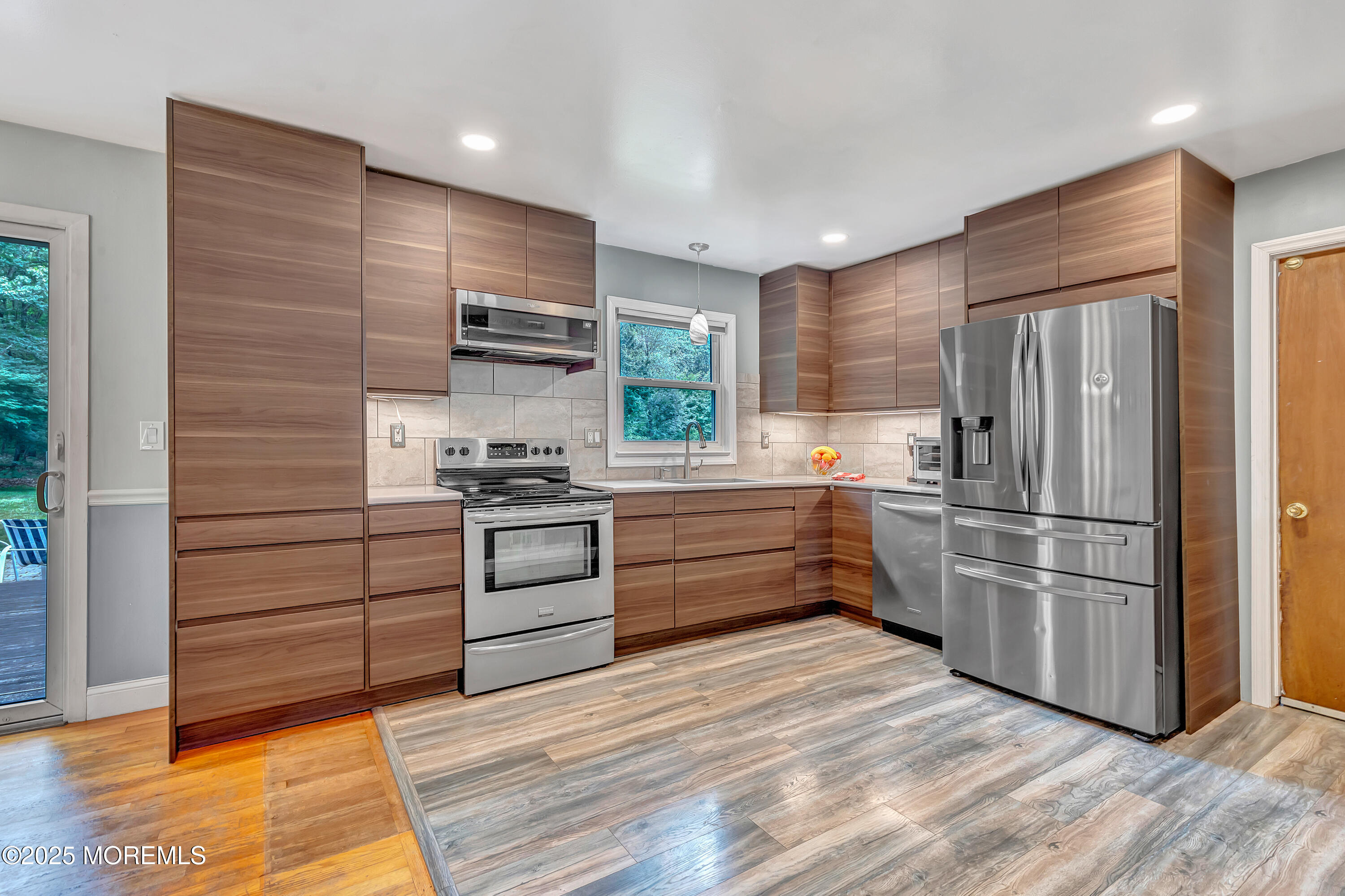 869 Wright Debow Road Jackson, NJ 08527 - Photo 8 of 34 a kitchen with a refrigerator and a stove top oven