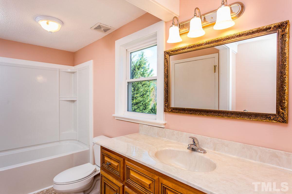 161 Prospect Avenue Raleigh, NC 27603 - Photo 15 of 24 a bathroom with a sink toilet and shower