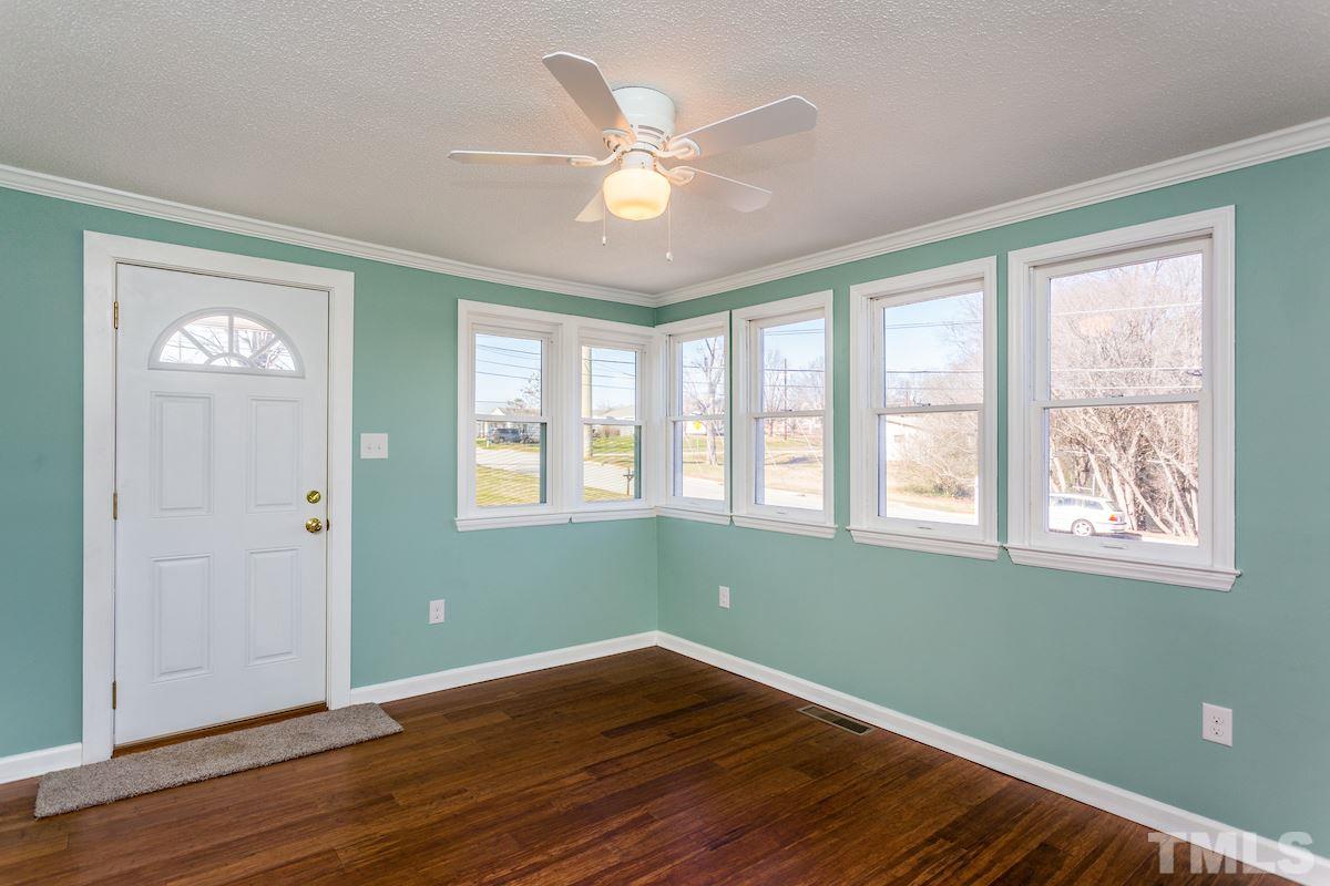 161 Prospect Avenue Raleigh, NC 27603 - Photo 3 of 24 a view of an empty room with wooden floor and a window