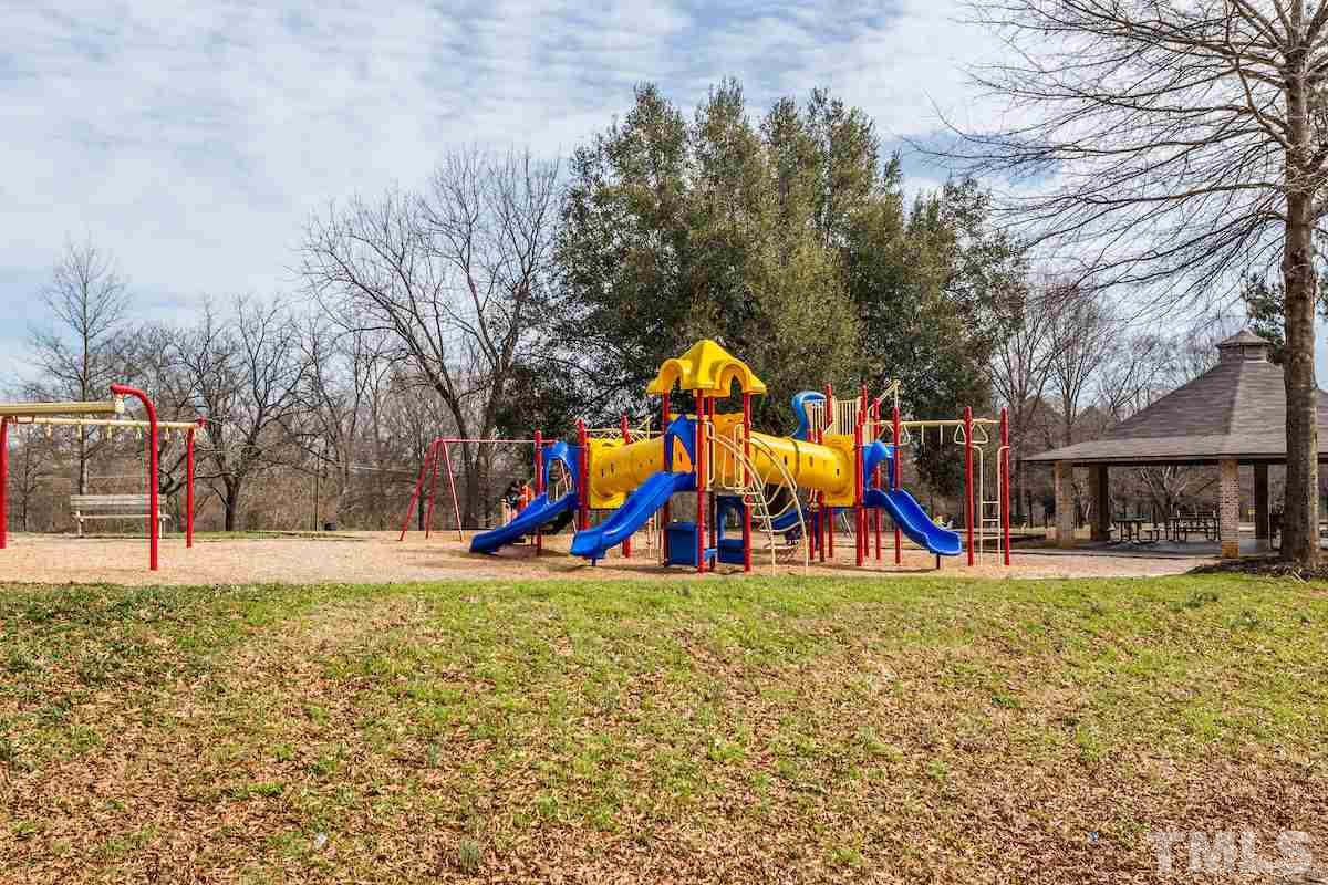 161 Prospect Avenue Raleigh, NC 27603 - Photo 22 of 24 a view of park with large trees and playing ground