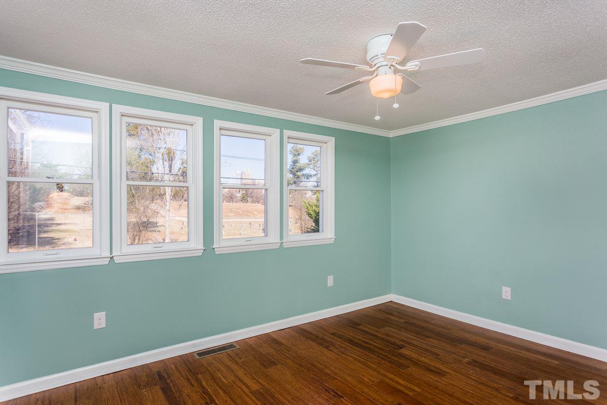 161 Prospect Avenue Raleigh, NC 27603 - Photo 4 of 24 a view of an empty room with wooden floor and a window