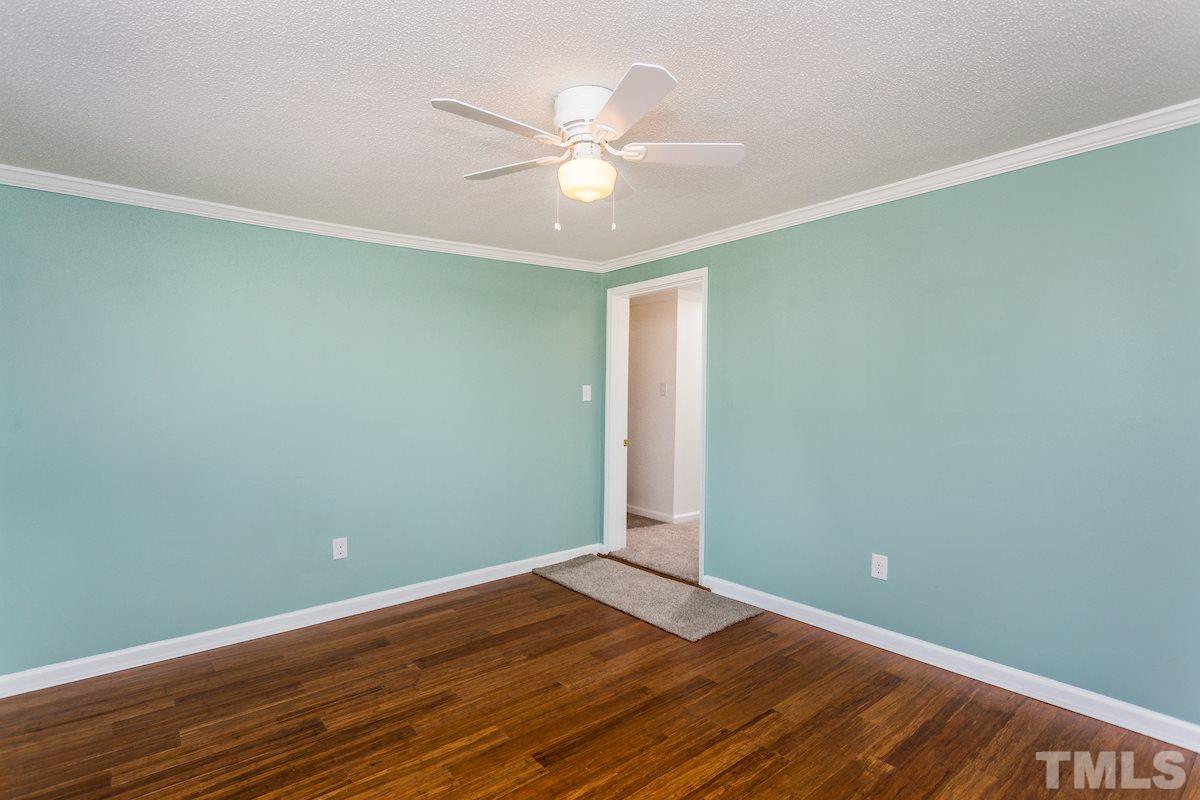 161 Prospect Avenue Raleigh, NC 27603 - Photo 5 of 24 an empty room with wooden floor and fan