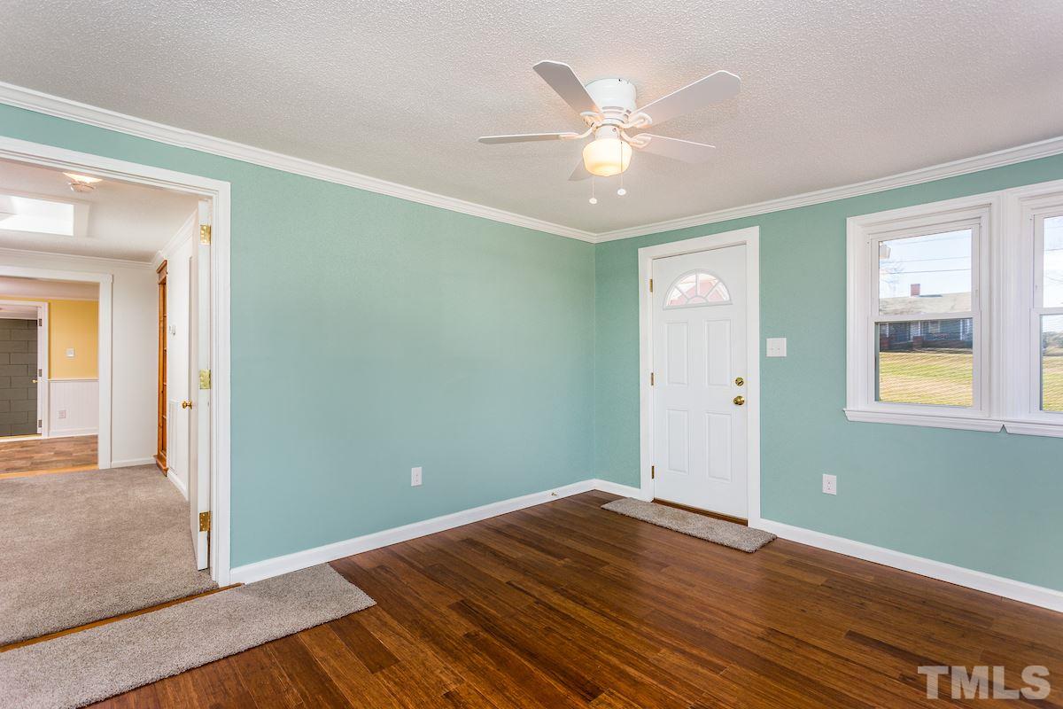 161 Prospect Avenue Raleigh, NC 27603 - Photo 6 of 24 wooden floor in an empty room with a window
