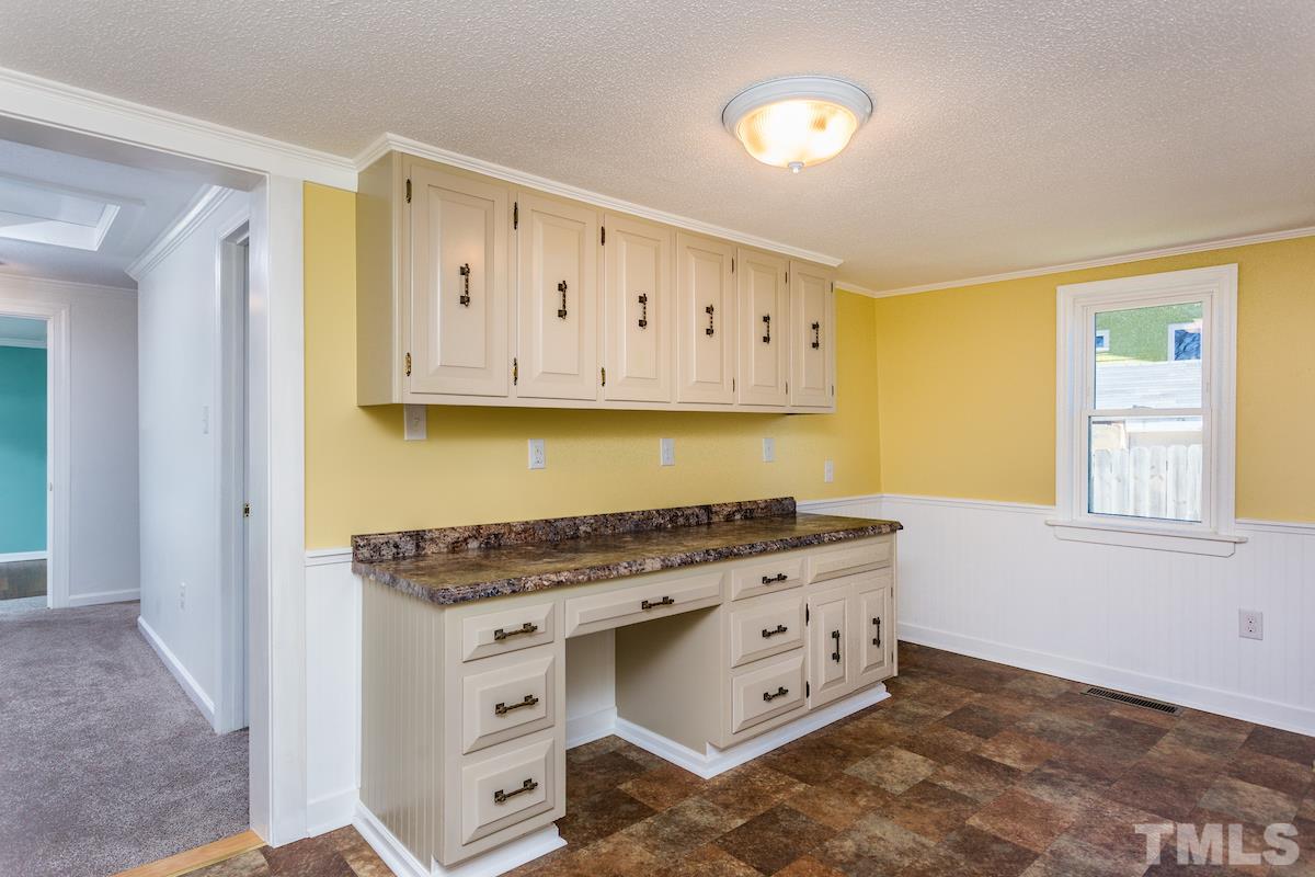 161 Prospect Avenue Raleigh, NC 27603 - Photo 8 of 24 a kitchen with stainless steel appliances granite countertop a stove and a white cabinets