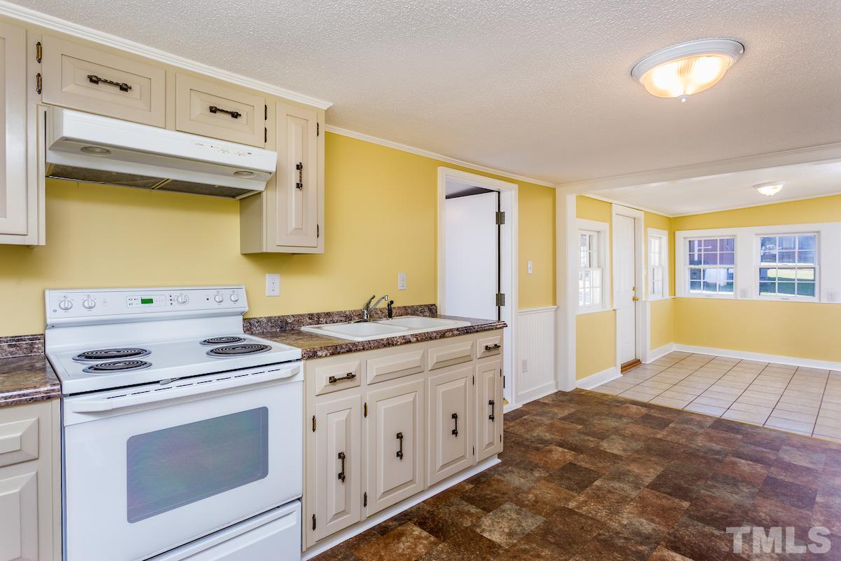 161 Prospect Avenue Raleigh, NC 27603 - Photo 9 of 24 a kitchen with stainless steel appliances white cabinets and a stove