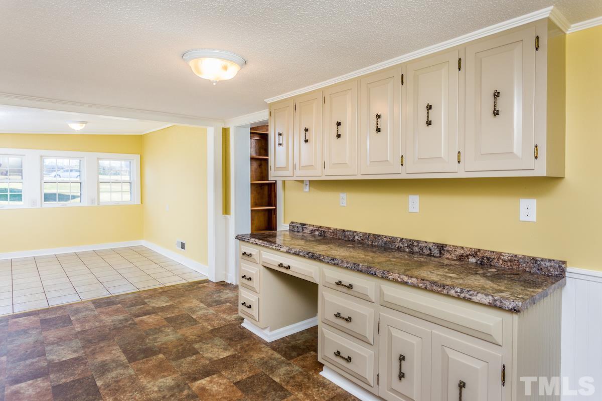 161 Prospect Avenue Raleigh, NC 27603 - Photo 10 of 24 a kitchen with granite countertop a stove a sink and a granite counter tops