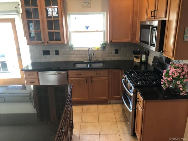 a kitchen with stainless steel appliances a sink stove and cabinets