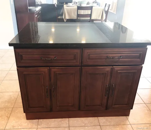 a kitchen with stainless steel appliances granite countertop a refrigerator a sink and a stove