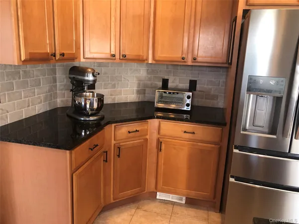 a kitchen with stainless steel appliances a refrigerator and cabinets